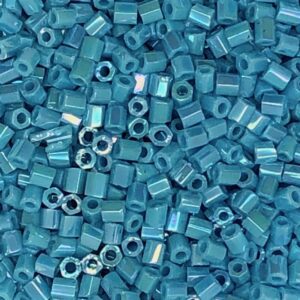 Blue seed beads scattered in close-up view.