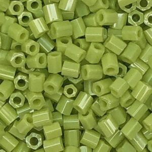 Green cylindrical plastic beads, close-up view.
