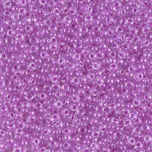 Close-up of small purple beads with central holes.