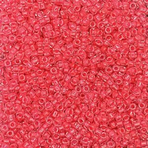 Close-up of numerous small, translucent red beads.