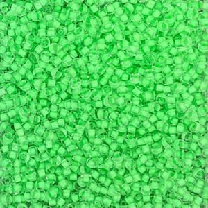 Close-up of small green plastic pellets scattered densely.