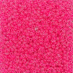 A close-up of numerous shiny pink beads densely packed together.