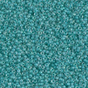 Close-up of numerous small turquoise beads scattered densely.