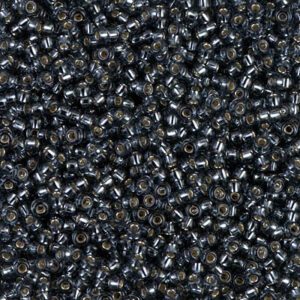 Close-up of small, shiny black plastic pellets.
