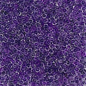 Close-up of numerous small purple beads with a shiny texture.
