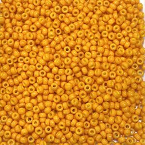 Close-up of numerous small orange beads with central holes.