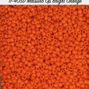 Close-up of bright orange seed beads with a matte finish.