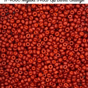 Close-up of numerous small red beads with holes in the center.
