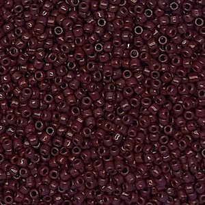 A close-up of small, dark red beads densely packed together.