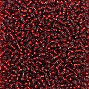 Close-up of numerous small, shiny red and black beads.