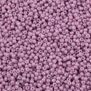 Close-up of small purple beads scattered densely.