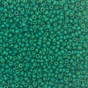 Close-up of numerous small green seed beads.