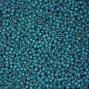 Close-up of numerous small blue beads with central holes.