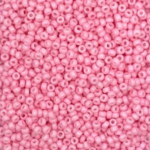 Close-up of small pink beads with holes.