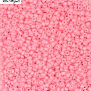 Close-up of numerous small pink beads scattered densely.