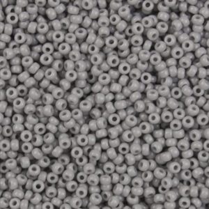 Close-up of numerous small gray plastic beads with holes.