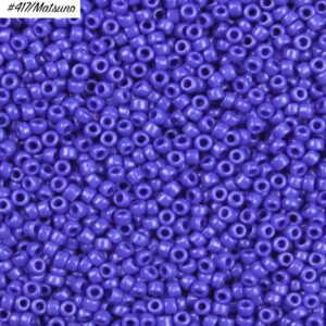 Close-up of small purple seed beads with a glossy finish.