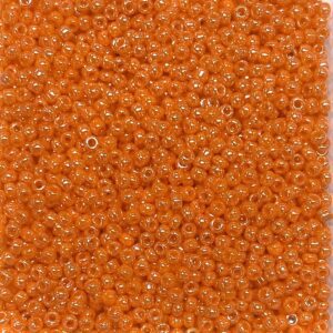 Close-up of numerous small orange beads packed tightly together.