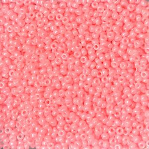 Close-up of small pink beads with a shiny finish.