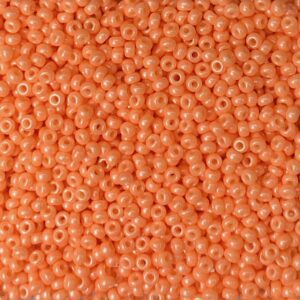 Close-up of small, round peach-colored beads.