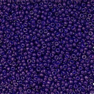 A close-up of numerous small, round, dark blue beads.