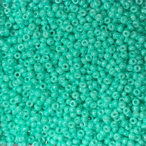 Close-up of small turquoise beads scattered densely.