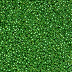 Close-up of numerous small green beads with holes in the center.