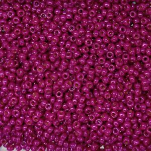 A close-up of numerous small, shiny magenta beads.
