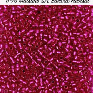 Close-up of small, shiny magenta seed beads.