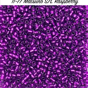 Close-up of shiny purple metallic beads labeled '11-11 Matsuno SL Raspberry'.