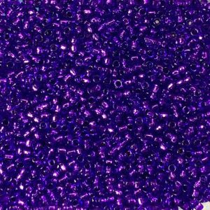 Close-up of small, shiny purple beads scattered densely.