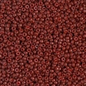 Close-up of small, round dark red beads densely packed together.