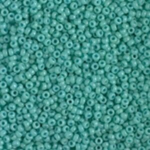 Close-up of numerous small turquoise seed beads.