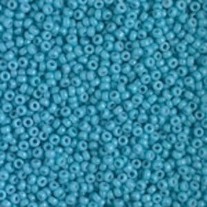 Close-up of small blue beads with a glossy finish.