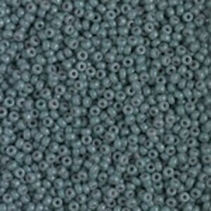 Close-up of small, round, teal-colored beads.