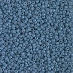 Close-up of numerous small blue seed beads.