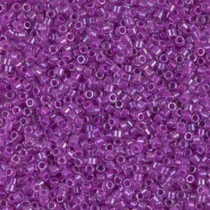 A close-up of small purple beads with holes in the center.