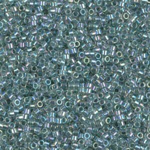 Close-up of small transparent blue beads with a shiny finish.