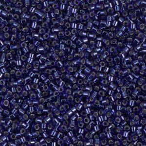 Close-up of tiny dark blue seed beads densely packed together.