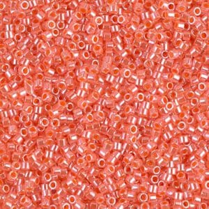 Close-up of small, translucent orange beads with white centers.