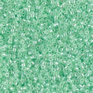 Close-up of tiny translucent green beads scattered uniformly.