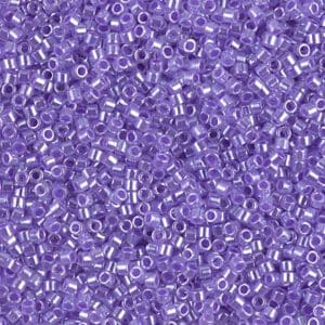 Close-up of tiny transparent purple beads scattered densely.