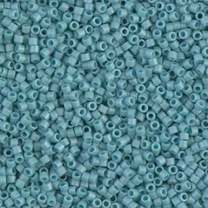Close-up of small blue cylindrical beads with central holes.