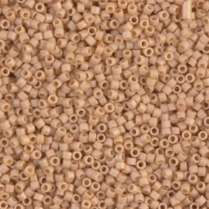 A close-up of numerous small beige seed beads.