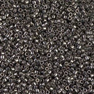 Close-up of small metallic cylindrical beads densely packed together.
