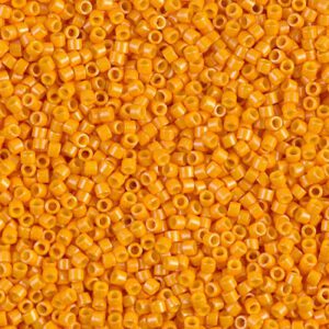 Close-up of small orange beads scattered densely together.