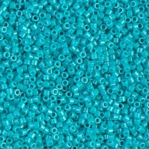 Close-up of small turquoise glass beads scattered densely.