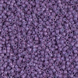 Close-up of small purple beads with a hole in the center.