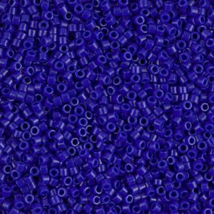 Close-up of small, dark blue cylindrical beads scattered densely.