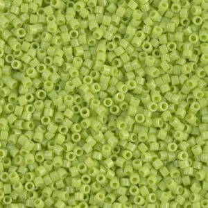 Close-up of small green seed beads scattered randomly.